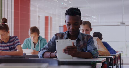 Image of stock market data processing over african american boy using digital tablet at school