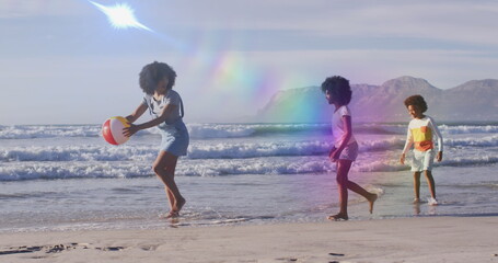 Fototapeta premium Image of light trails over african american family at beach