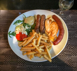 Dinner of assorted sausages and chicken