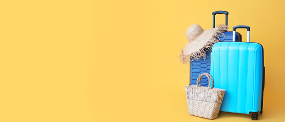 Obraz premium Packed suitcase with beach accessories on color background. Travel concept