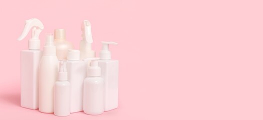 Different cosmetic products on pink  background with space for text