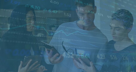 Image of stock market data processing against group of diverse colleagues discussing at office