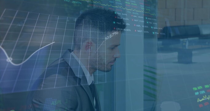 Image of stock market data processing against biracial businessman using laptop at office