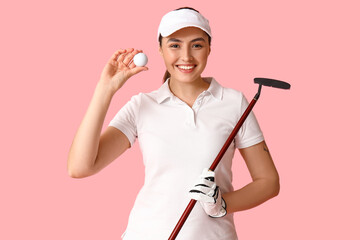 Beautiful female golfer on pink background