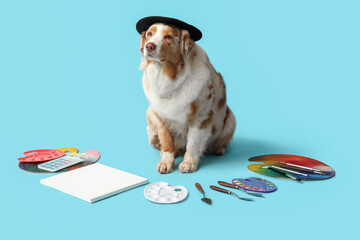 Cute dog with artist's supplies on blue background