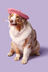 Cute dog in beret and with paint brush on lilac background