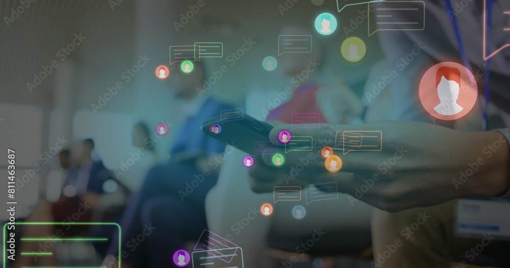 Poster image of neon profile and message icons over mid section of a man using smartphone at office