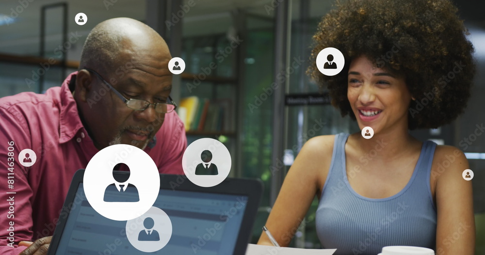 Poster image of profile icon in circles over diverse coworkers talking while working in office