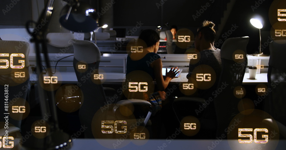 Poster image of multiple 5g texts over rear view of diverse coworkers discussing reports in office