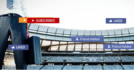 Image of social media icons floating over low section of businessman against sports stadium