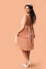 Beautiful young African-American woman in stylish prom dress and tiara on brown background © Pixel-Shot
