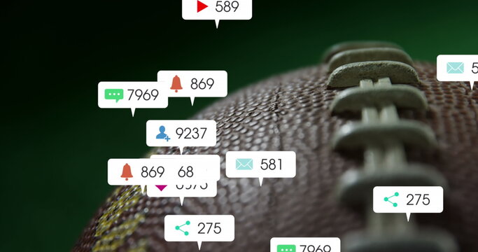 Image of changing numbers, icons in notification bars over close up of rugby ball - Powered by Adobe