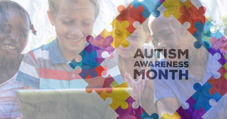 Image of autism awareness text and colorful puzzle pieces over happy playing children