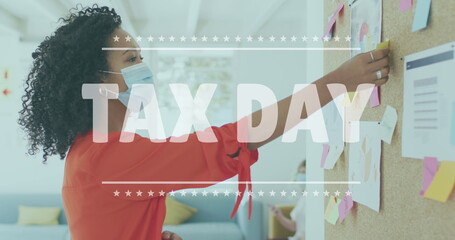 Tax day text banner against african american woman reading memo notes at office