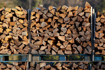 Firewood stacked - wood logs, background texture.





