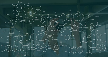 Image of chemical formulas over caucasian women using vr headset