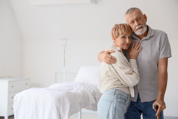 Mature couple hugging in clinic