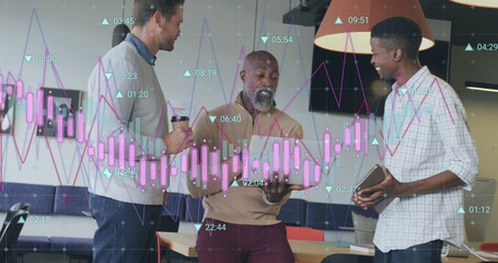 Image of multiple graphs with changing numbers, diverse coworkers discussing in office