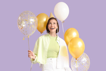 Beautiful woman in party hat with Birthday balloons on lilac background