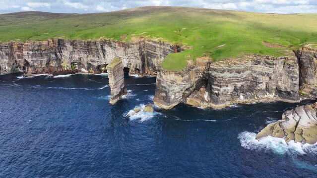 Aerial View of Sea Stack and Steep Cliffs on Coastline of Scotland UK, Cinematic Drone Shot