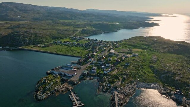 Aerial view rising in front of the Bugoynes village, summer day in Finmark, Norway