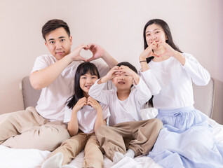 A family of four in bed in the bedroom