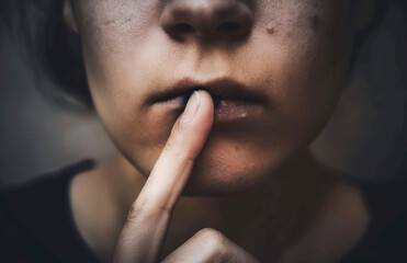 Close-Up of Woman's Lips with Finger Shushing