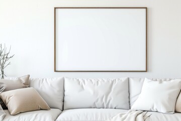 Cozy living space with beige sofa and a blank framed poster on a soft wall