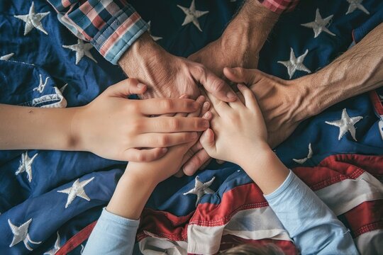 A diverse group of hands coming together over an American flag, symbolizing unity and patriotism among different ages and races. 4th of July, american independence day, memorial day concept