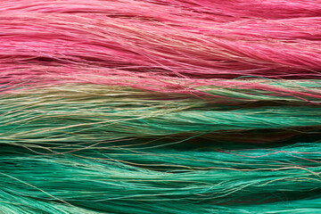 Obraz premium close-up of colorful coconut husk fiber or coir, commercially important natural fiber extracted from outer husk of coconut fruit dyed from traditional method, background texture backdrop