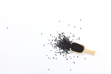 Black cumin, black seed, scattered seeds, on a white background, free space, place for text, top view