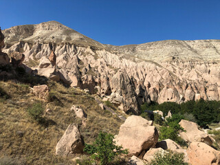 Fototapeta premium Aerial drone shot of the Fairy Chimneys over the landscape of Goreme, Cappadocia.