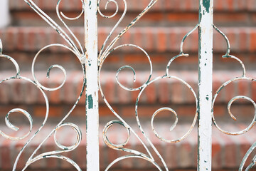old cast metal wrought fence with rust close up