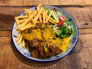 luxury fine dining western halal cuisine main course menu crispy fried chicken chop with salted egg yolk sauce and french fries salad vegetable tomato hotel restaurant banquet asian cafe on wood table
