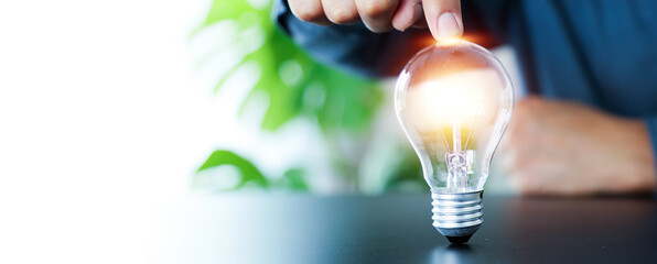 Close up hand choose light bulb or lamp with bright for human resources or leadership and...