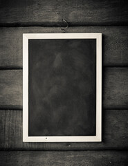 empty Blank chalkboard in wooden frame isolated on wooden background