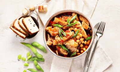 Soybean with soy meat, onion and tofu on light wooden background. Vegan food