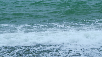 Azure Pure Turquoise Ocean On A Warm Summer Day. Sea Blue Water Waves Foam. Slow motion.