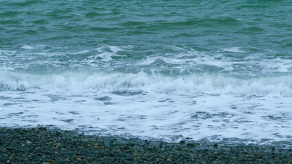 White Foam Waves In Bright Blue Green Sea. Crystal Blue Waves With White Foam. Slow motion.