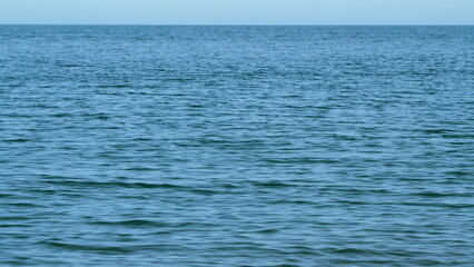 Wavy Sea With Horizon At A Blue Sky. Calming Waves Of The Sea Or Ocean. Sunny Summer Day. Still.