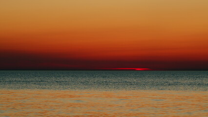 Sunset Over Sea. Sun Reflected In Sea Ray And Sunrise Or Sunset Over Calm Sea. Slow motion.