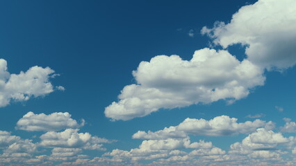 Cumulus Cloudscape. Beautiful Movement Of Puffy Fluffy White Clouds Fly Across Clear Blue Sky.
