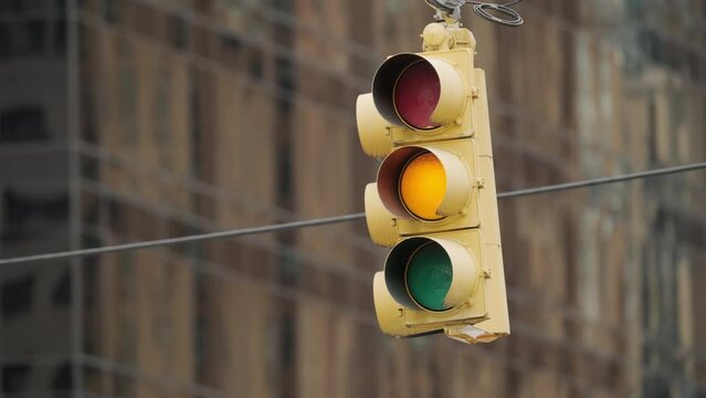 Traffic light in New York City changing from green to red close up