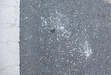 Shards of glass or broken glass lie on the asphalt road.