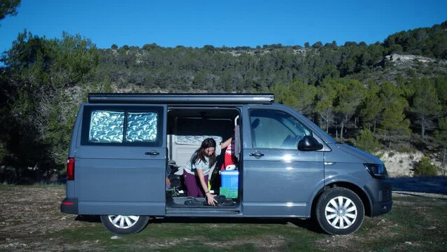 Woman in campervan at morning in nature. High quality 4k footage
