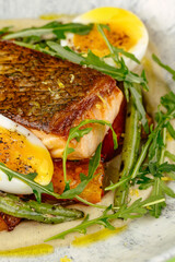 fried fish in a side dish on a plate