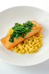 grilled salmon with side dish and sauce