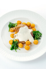 grilled duck leg with side dish on a white plate