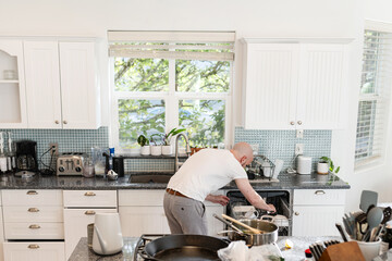 Man doing dishes at kitchen sink