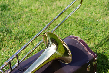 Trombone Resting on Its Case in a Field During Marching Band Rehearsal
